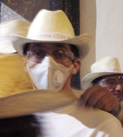Man wearing a dust mask, at the carnival fiesta of los indianos, santa cruz de la Palma.